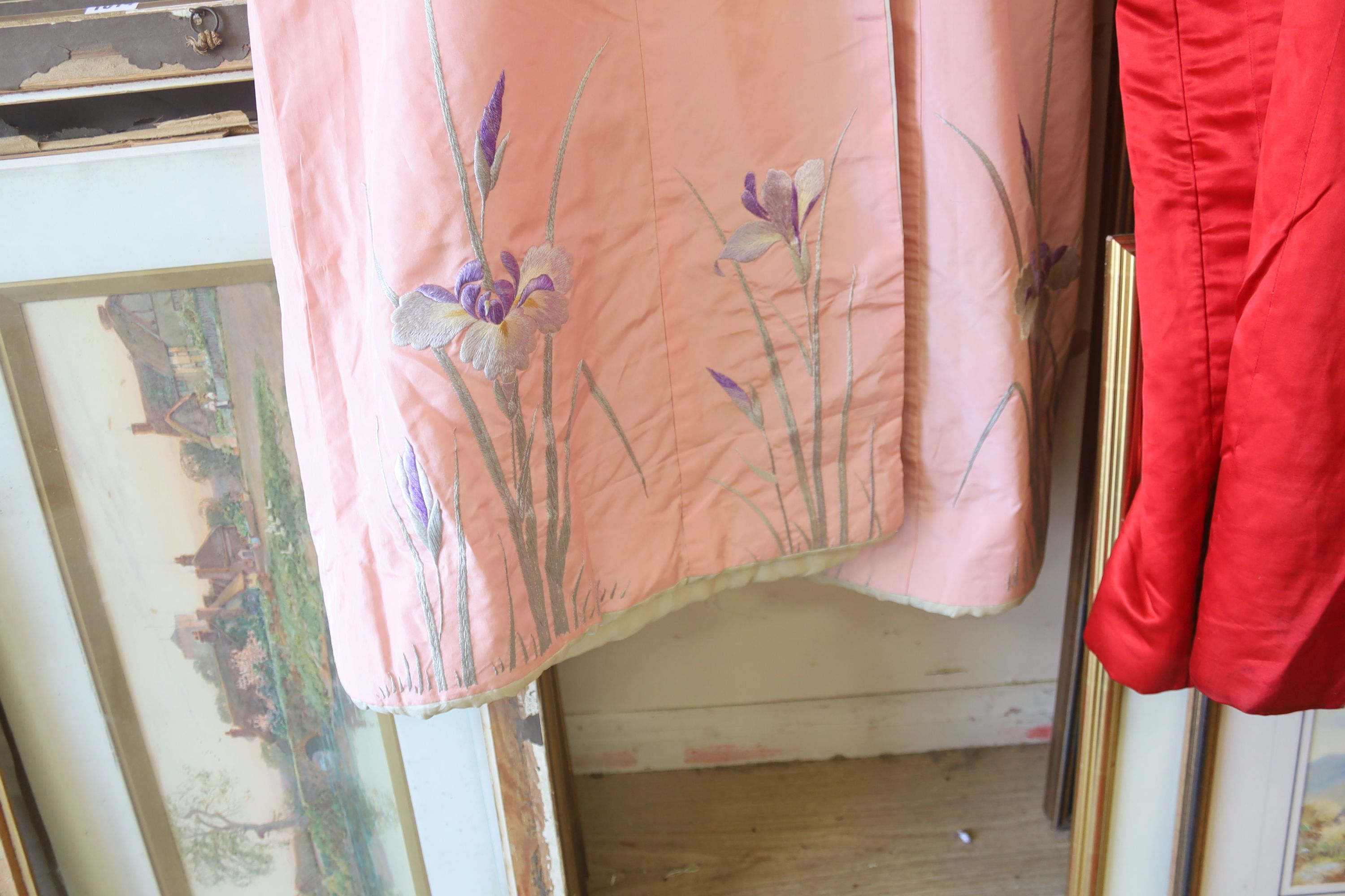 A pink silk Japanese kimono embroidered with wisteria and irises and butterflies, length 140cm, together with a red kimono embroidered with white wisteria and carnations